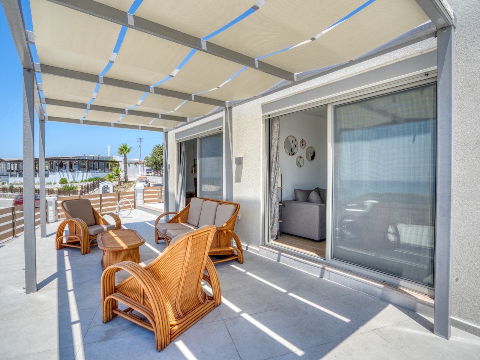 Terrace lounge with rattan furniture under the pergola