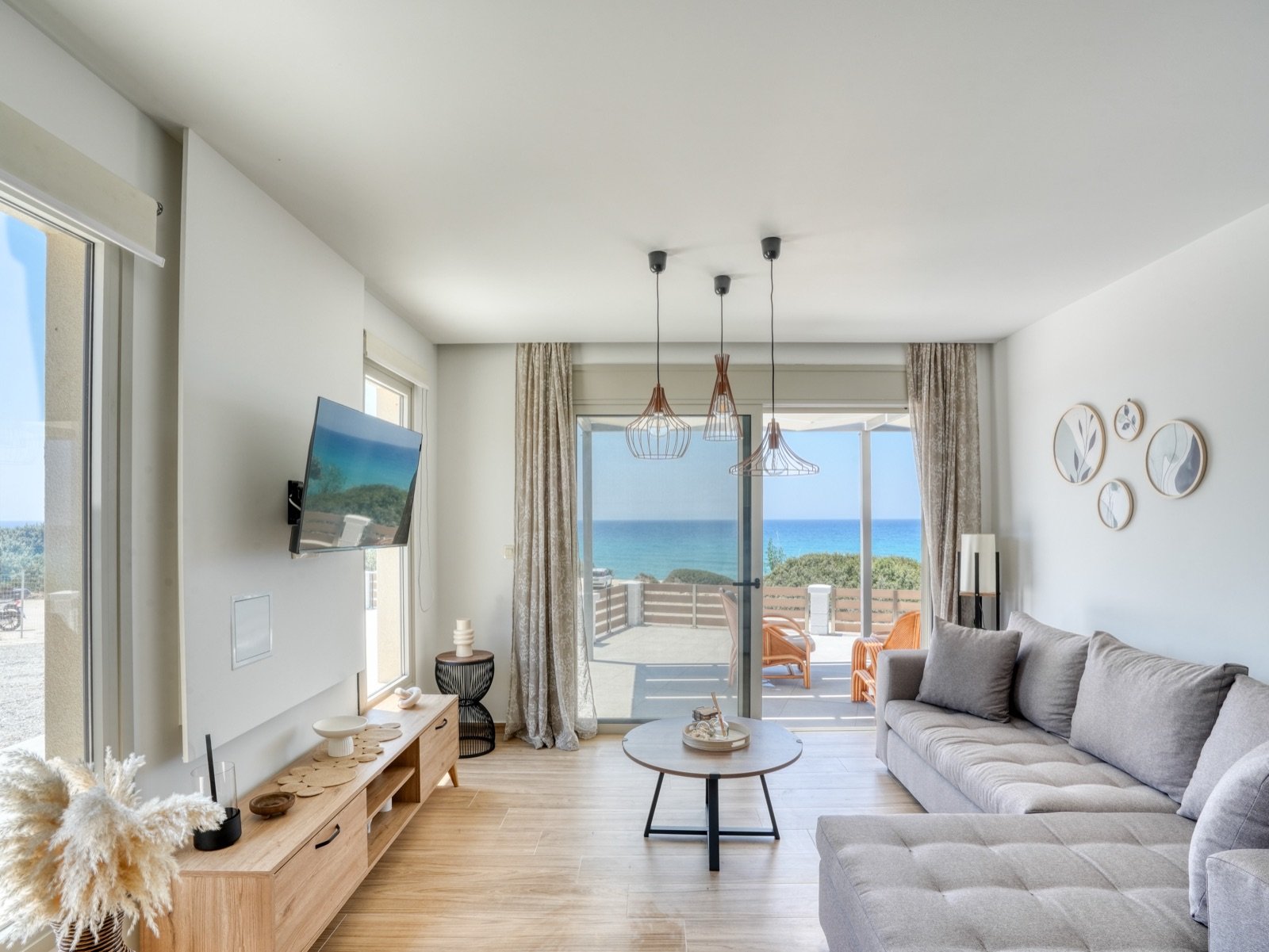 Open-plan living room with sea view through sliding doors