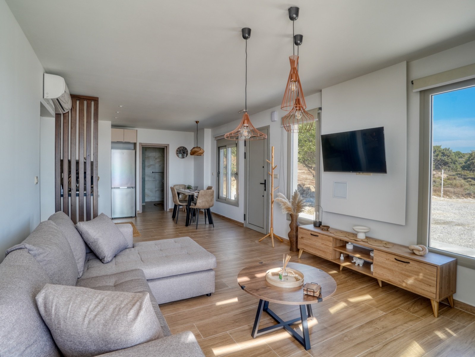 Bright living area with TV and dining corner