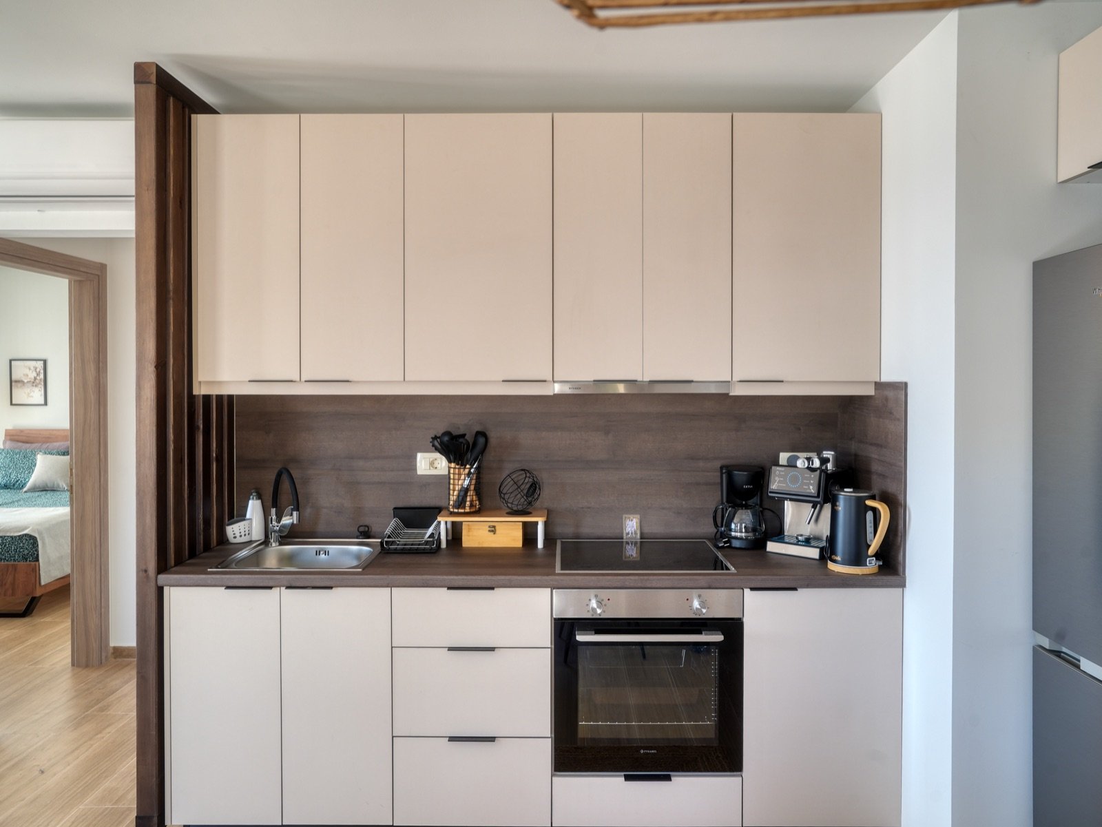 Kitchen with oven, hob and coffee machine