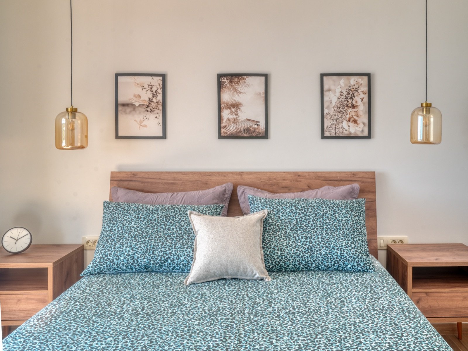 Bedroom detail with pendant lights and framed art