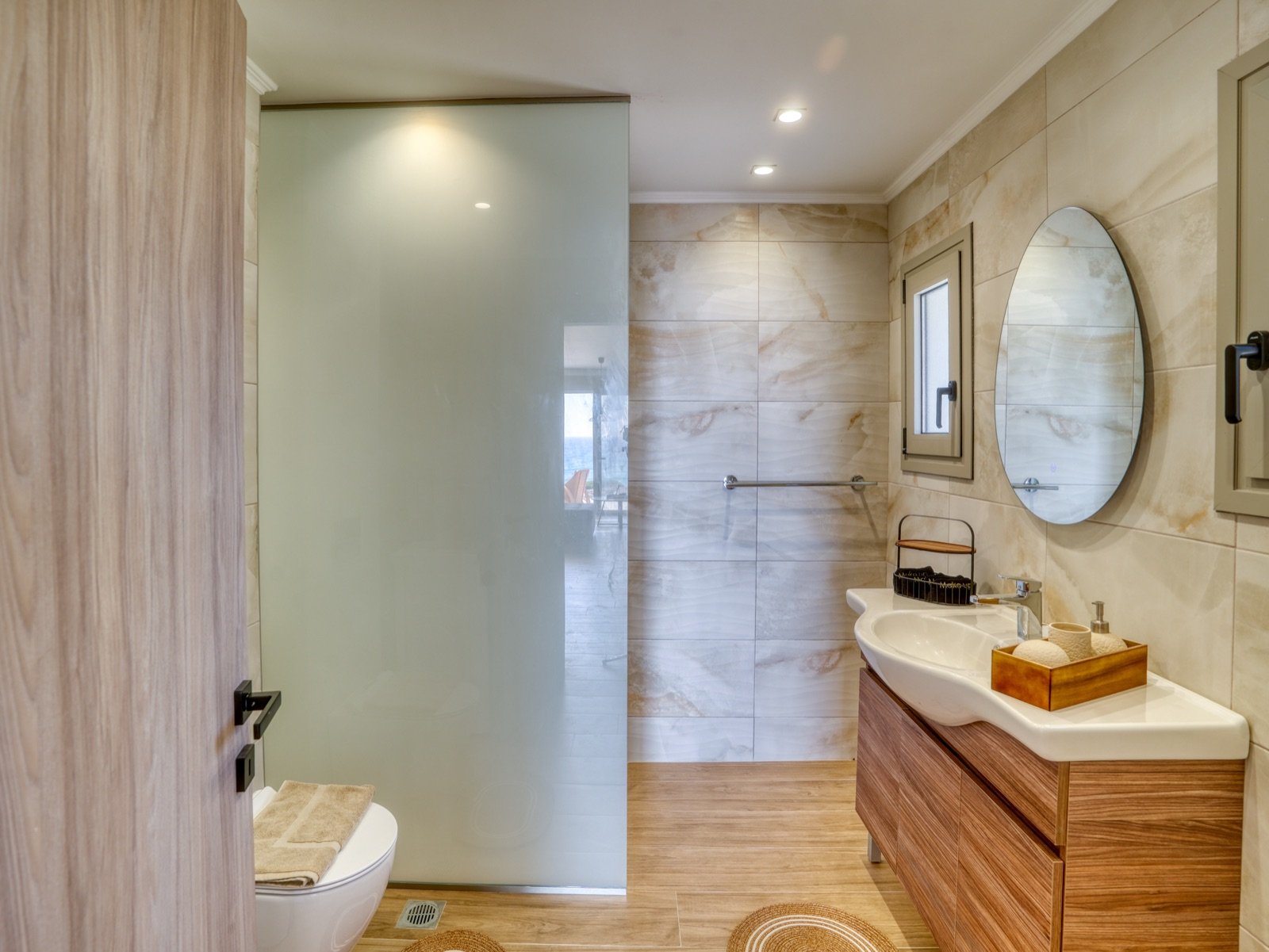 Modern bathroom with walk-in shower and onyx-style tiles